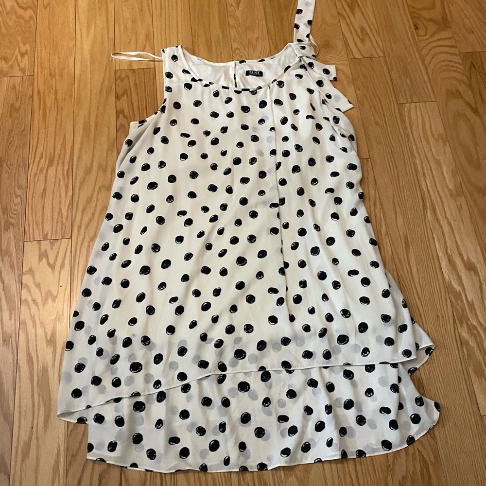 Creamy white SLNY dress with black dots, bow on shoulder and layered hem.